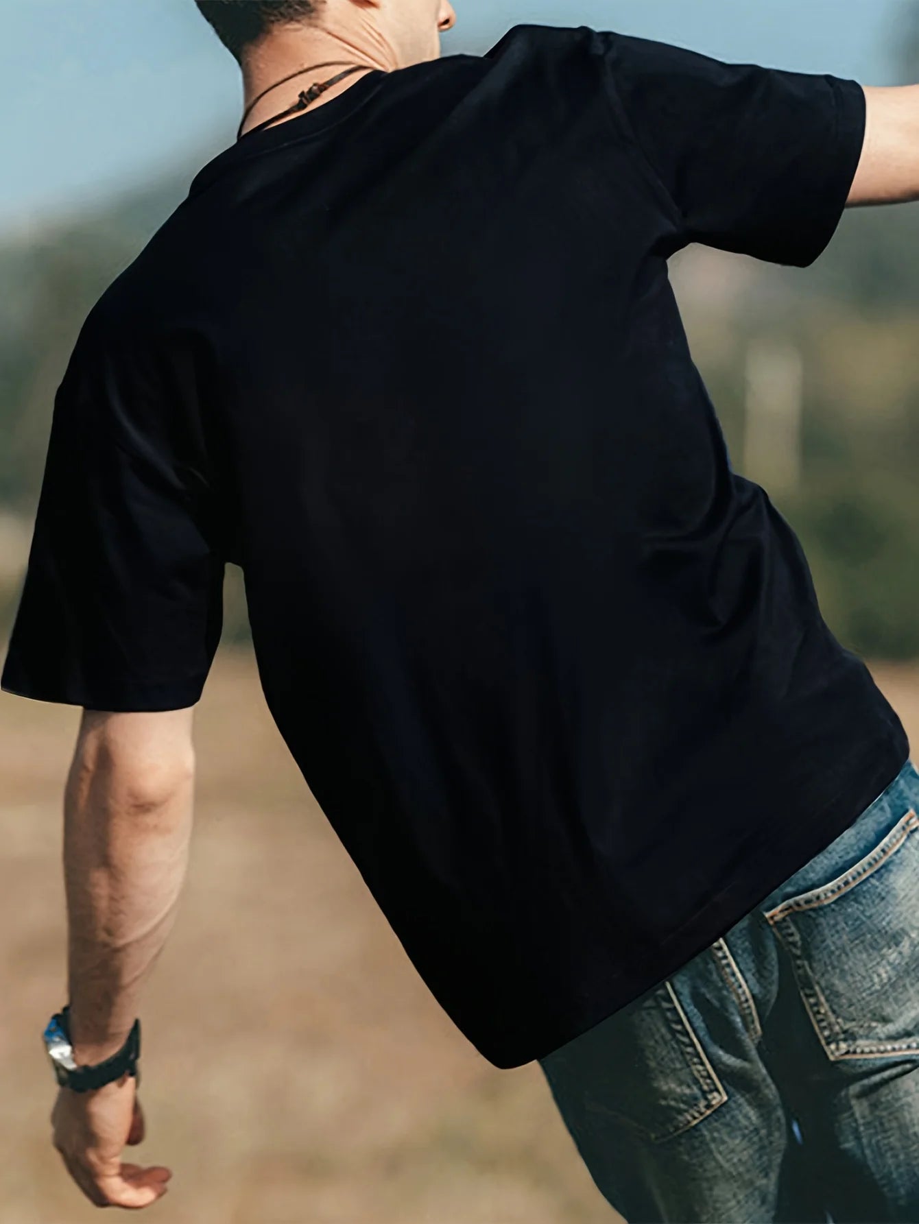 Angel, Nirvana Rebirth, Pattern Front Print, Men's Short sleeved T-shirt worn outdoors from the back.