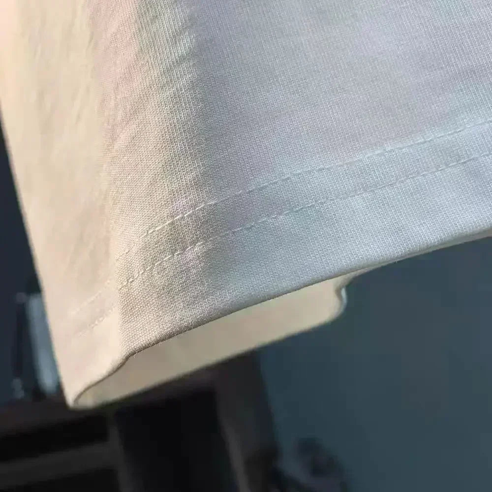 Close-up of the hem on the Pierce The Veil Band T-Shirt - Black Unisex Cotton Crew Neck Tee, showcasing quality stitching.