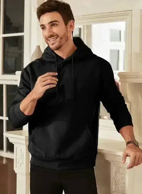 Men's vintage patterned hooded sweatshirt long sleeves drawstring hood sporty autumn pullover in black worn by a smiling man.