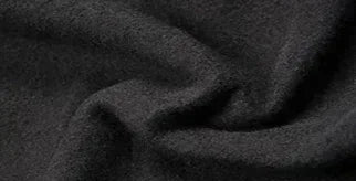 Close-up view of soft black fabric texture for clothing, suitable for making comfortable autumn apparel.